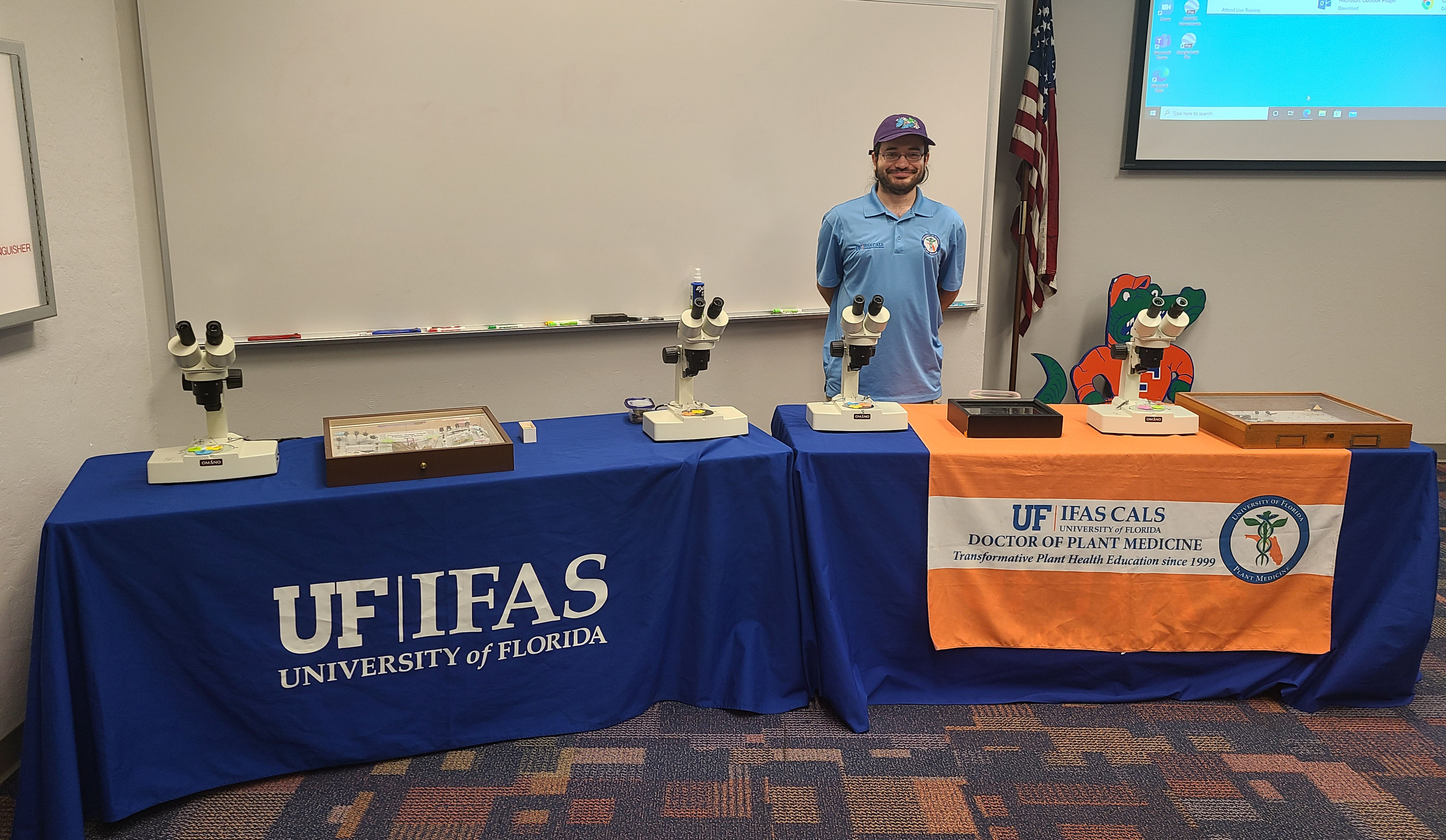 dpm student at FLFD table with insect displays and microscopes